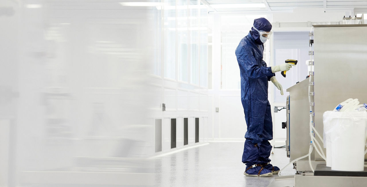 Technician in PPE working in ISO certified cleanroom