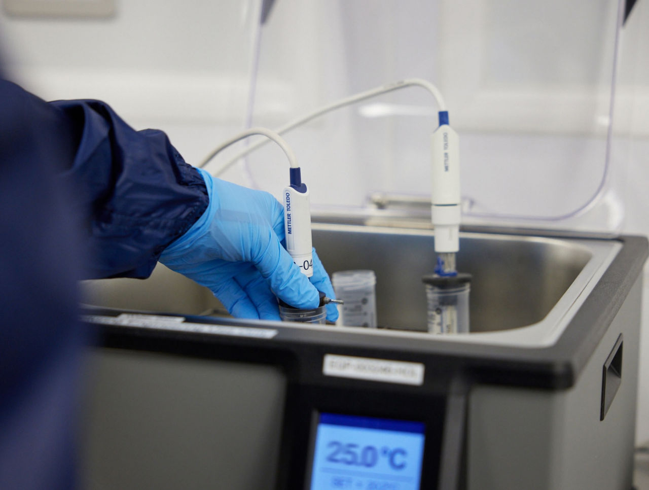 Close up of person performing pH and conductivity testing